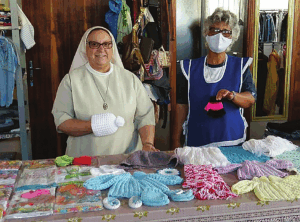 the sisters knitting and making clothes for the community